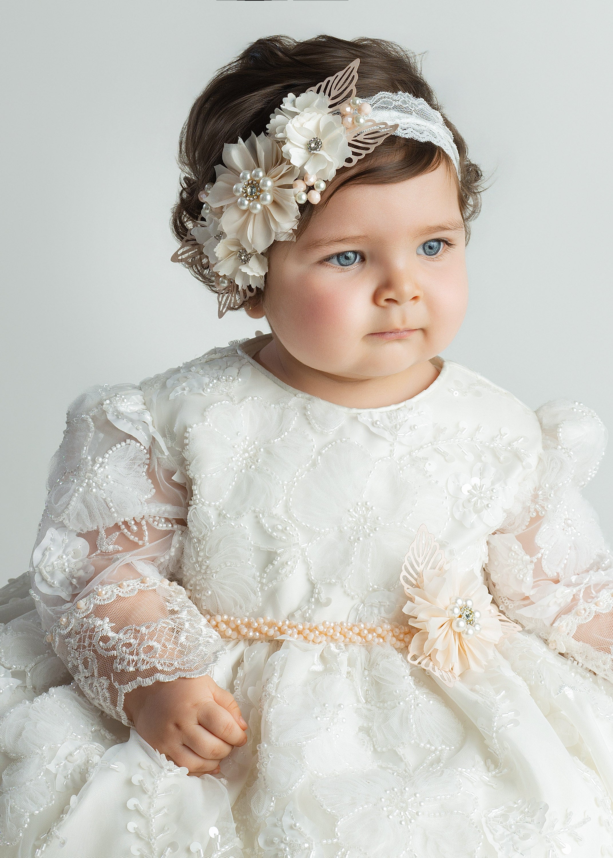 Baby girl wearing G064 baptism gown with floral embroidery and matching headband