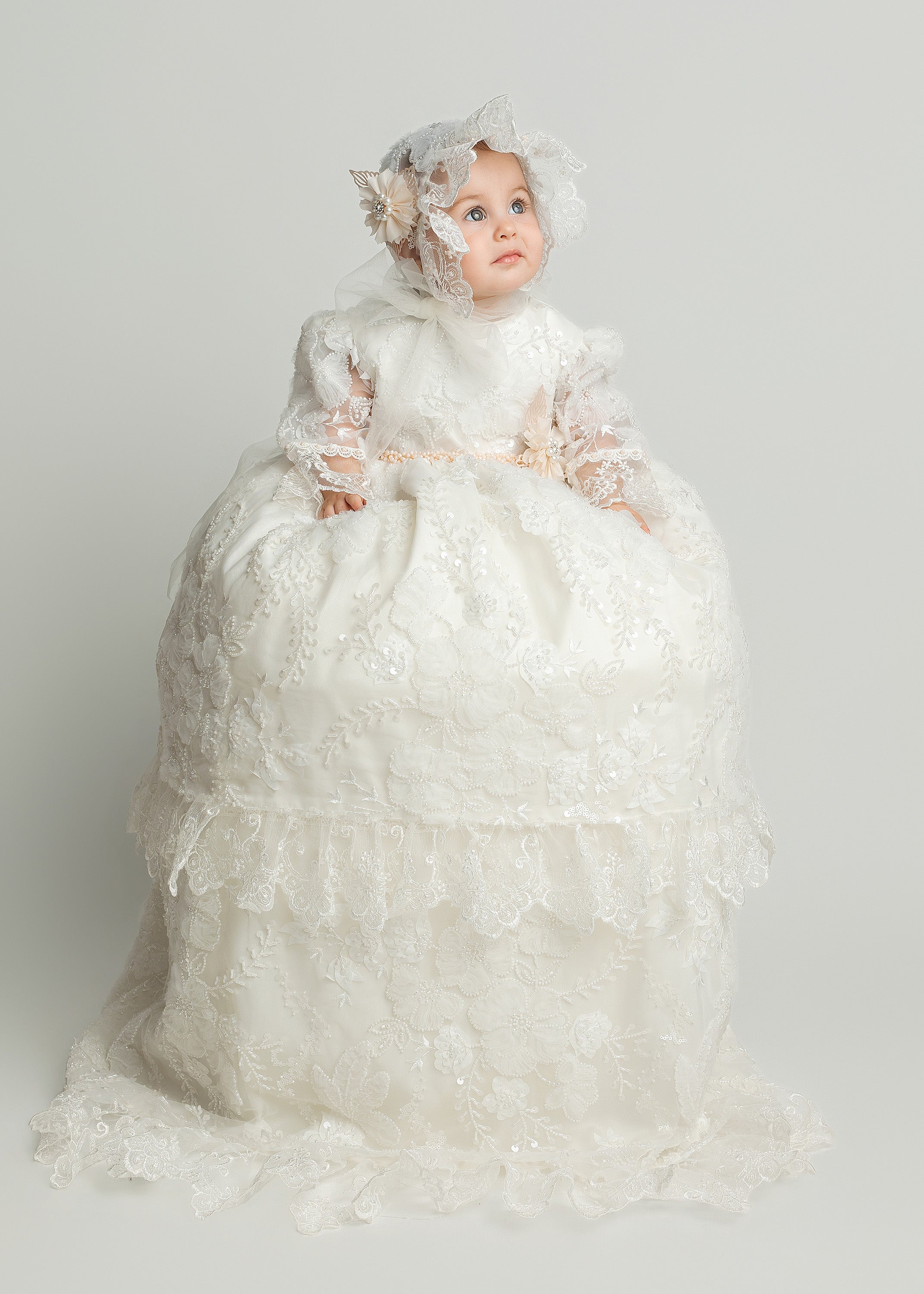 Baby girl wearing G064 ivory christening gown with long detachable skirt and matching bonnet